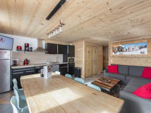 a kitchen and a living room with a wooden ceiling at Spacieux appart. 12 pers. au cœur de Val Thorens avec balcon et WiFi - FR-1-640-3 in Val Thorens