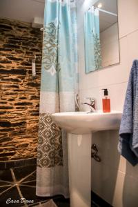 a bathroom with a sink and a shower curtain at Casa Rural Dana 