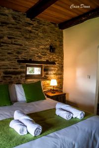 a bedroom with a bed with towels on it at Casa Rural Dana in Castelo +45 photos