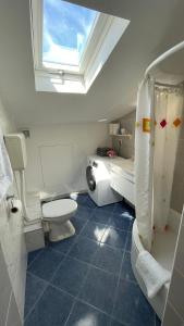 a bathroom with a toilet and a sink and a window at Apartmans and Rooms Madunic M in Split