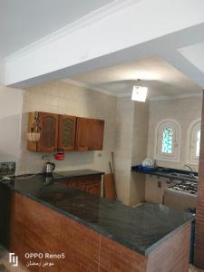 a kitchen with wooden cabinets and a counter top at North coast in El Alamein