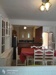 a kitchen and dining room with a table and chairs at North coast in El Alamein