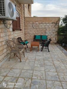 a patio with chairs and a table and a heater at North coast in El Alamein
