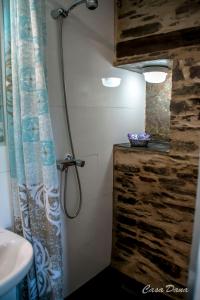 a bathroom with a shower curtain and a sink at Casa Rural Dana 