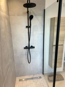 a shower with a black shower head in a bathroom at Maison de Ville Cannes Centre in Cannes