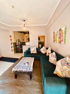 a living room with two green couches and a coffee table at El-sheikh Salem villa in Dahab