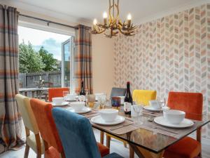 a dining room with a table and chairs at Eagle Lodge - Aviemore Lodges in Aviemore