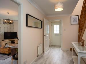 a living room with a mirror and a television at Eagle Lodge - Aviemore Lodges in Aviemore