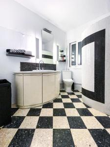 a bathroom with a black and white checkered floor at Casa Bianca Elegant House Near Beach in Spetses +34 photos