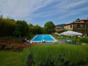 a swimming pool in the yard of a house at Villa della Corte - Homelike Villas in Erbusco