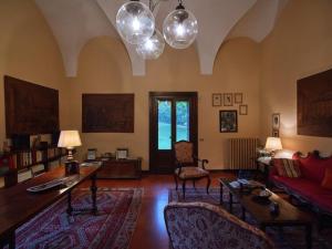 a living room with a couch and a table at Villa della Corte - Homelike Villas in Erbusco