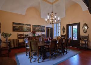 une salle à manger avec une table, des chaises et un lustre dans l'établissement Villa della Corte - Homelike Villas, à Erbusco