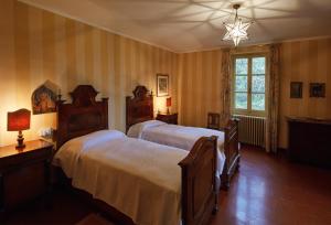 a bedroom with two beds and a window at Villa della Corte - Homelike Villas in Erbusco +11 photos