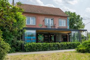 a house with glass windows and a balcony at Lemon Market rooms in Zagreb