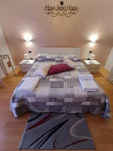 a large bed in a room with two night stands at Panoramic in Troina