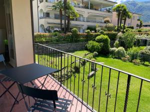 a balcony with a table and a view of a building at Ascona Casa Farfalla 1 in Ascona +23 photos