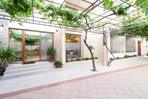 an office building with a glass ceiling and plants at Apart-Hotel President in Ulcinj