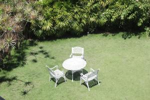 a table and four chairs in a yard at Laluna Ayurveda Resort in Bentota