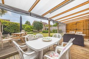 a white table and chairs on a wooden deck at 3-Bed Family Home with Parking & Large Garden in Windsor