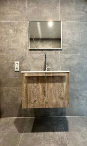 a bathroom with a sink and a mirror at Sunshine B&B in Utrecht