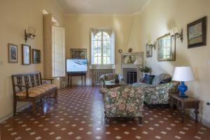 a living room with chairs and a tv and a couch at Villa Eden - Homelike Villas in Forte dei Marmi