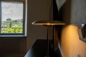 a stool in a room with a window at Forma Your Boutique Suite in Corciano