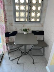 a table and two chairs in a room with a window at RIBERA PLAYA ALHAMAR in Sitio de Calahonda +15 photos