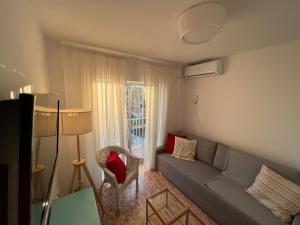 a living room with a couch and a window at RIBERA PLAYA ALHAMAR in Sitio de Calahonda