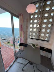 a room with a desk and a balcony with the ocean at RIBERA PLAYA ALHAMAR in Sitio de Calahonda