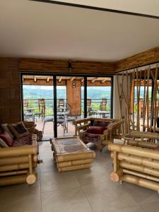 a living room with wooden furniture and a view of the ocean at Zdravkovac Country Club - Hotel in Topola
