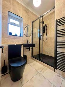 a bathroom with a shower and a toilet and a sink at The Saddle Inn, Snetterton Circuit in Norwich