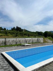 une grande piscine avec un filet de volley-ball dans l'établissement Zdravkovac Country Club - Hotel, à Topola