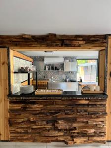 a kitchen with a counter made out of logs at Zdravkovac Country Club - Hotel in Topola
