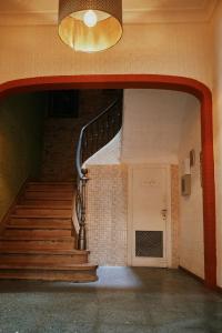 a staircase in a building with a chandelier at LOFT HOSTAL Group in Lloret de Mar