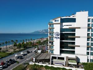 a large white building with the ocean in the background at PEARLY HOTEL in Antalya