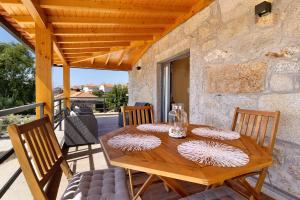 a wooden table and chairs on a patio at Casa da Lage in Castelo do Neiva