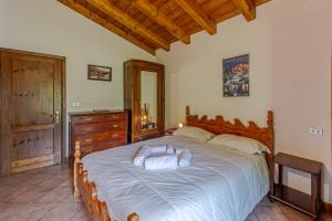 a woman laying on a bed in a bedroom at Baita Girasole Val Veny in Courmayeur