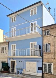a blue building with a balcony on top of it at CASA DEL MARINAIO - Relax in pieno centro - WiFi - 6 posti in Porto SantʼElpidio