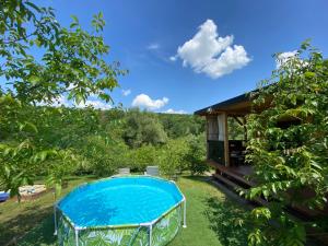 a house with a swimming pool in the yard at Rajski Domek in Sadowie