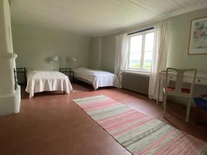 a room with two beds and a large window at Gåvetorps Gård in Alvesta