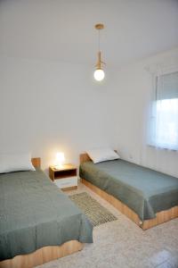 a bedroom with two beds and a window at J&M FALIRAKI in Faliraki
