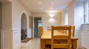 a dining room with a wooden table and chairs at Keepers Cottage in Rusland
