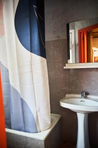 a bathroom with a sink and a shower curtain at LOFT HOSTAL Group in Lloret de Mar