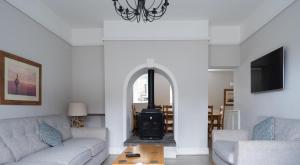 a living room with a wood stove in a living room at Keepers Cottage in Rusland