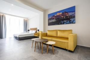 a living room with a couch and a bed at Aristotelous Downtown Suites in Thessaloniki