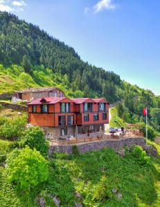 a large house on top of a mountain at Panorama Otel in Uzungol