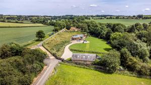 an aerial view of an estate with a barn and a road at Acorn Lodge At Bridge Lake Farm & Fishery in Banbury
