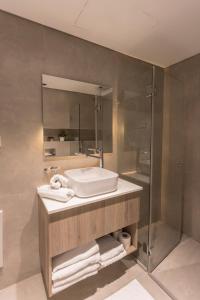 a bathroom with a sink and a shower at AMALON Boutique Apartments in Jerusalem