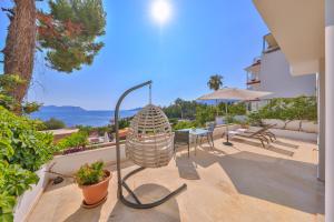 a patio with a lamp and a table and chairs at Gardenia Hotel in Kas