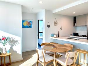a kitchen and dining room with a table and chairs at Sweet Home Apartment Melbourne CBD in Melbourne